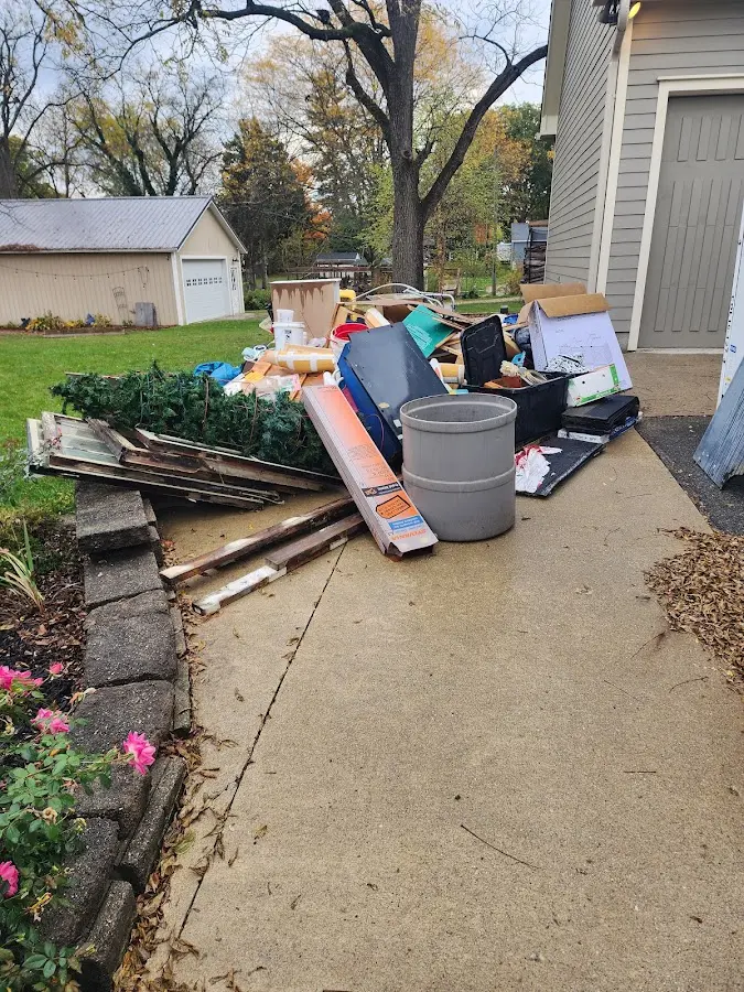 Dumpster being loaded with debris for Roofing Dumpster Rental in Lacy-Lakeview